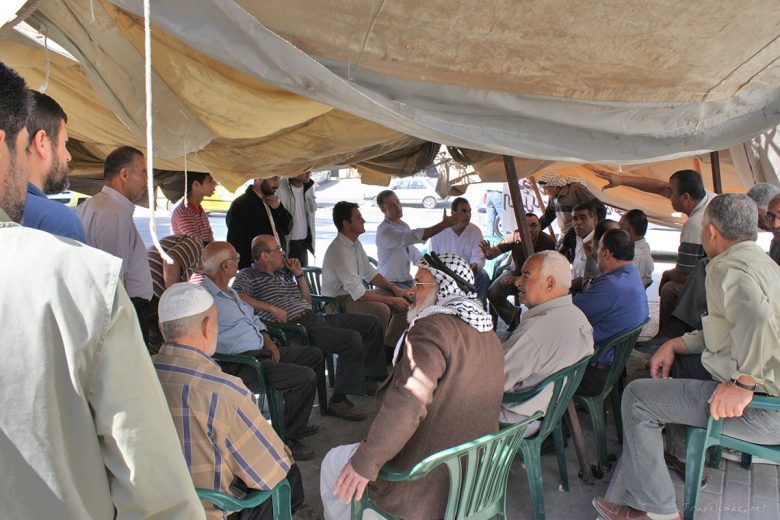 Witnessing negociations about the living conditions which are held several times a week under an improvised tent