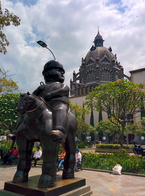 Botero sculpture in front of Uribe palace of culture in downtown Medellin, designed by a Flemish architect